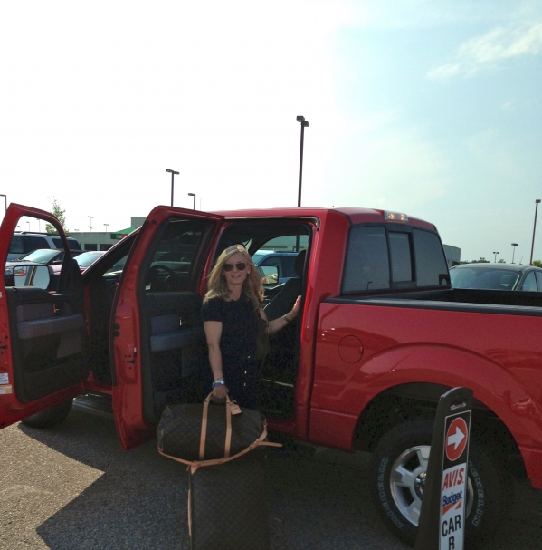 A girlfriend will agree that a completely impractical quad cab red pick up is the JUST RIGHT rental for no good reason